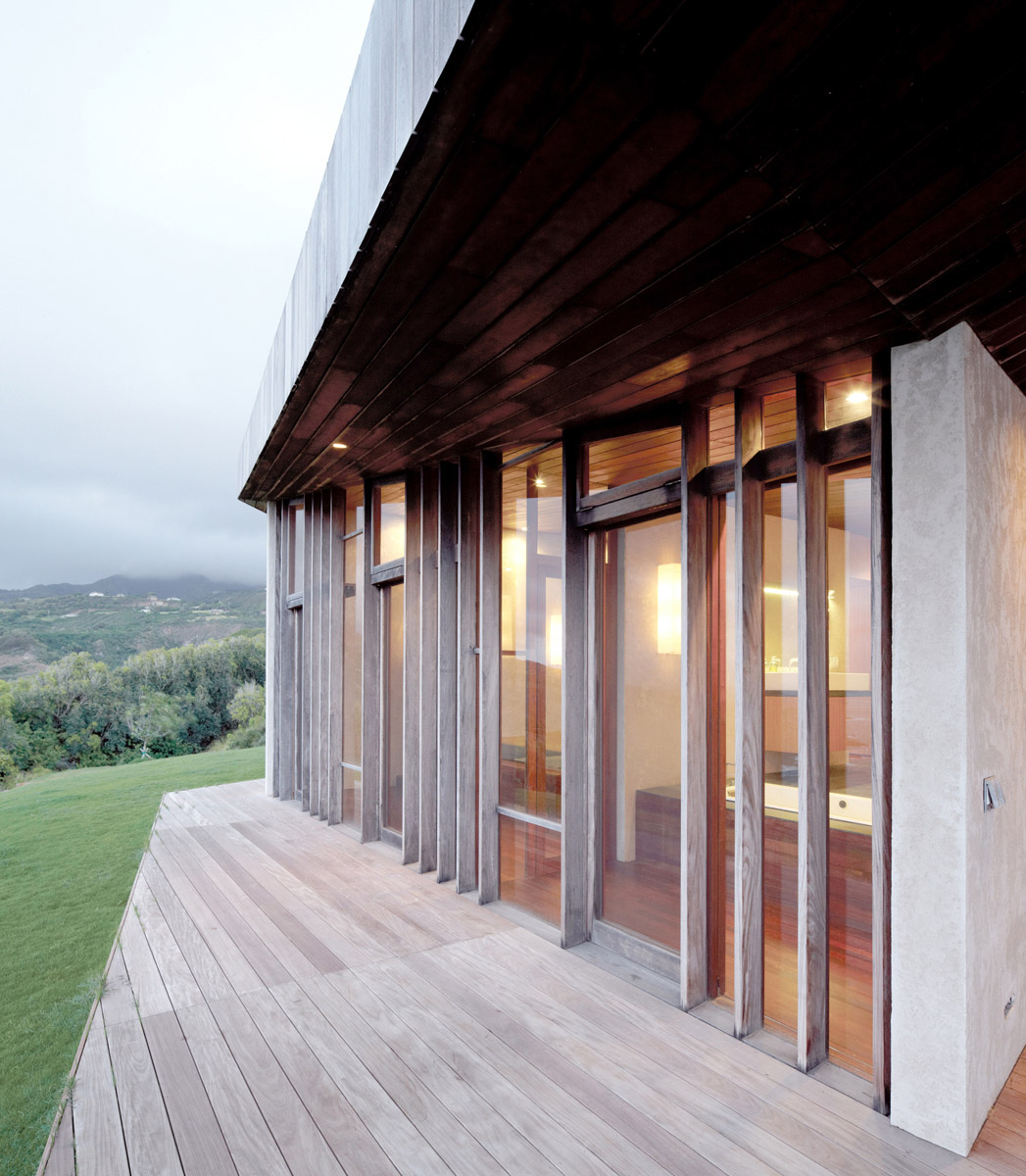 Home on a cliff in Hawaii. A common roof encloses several