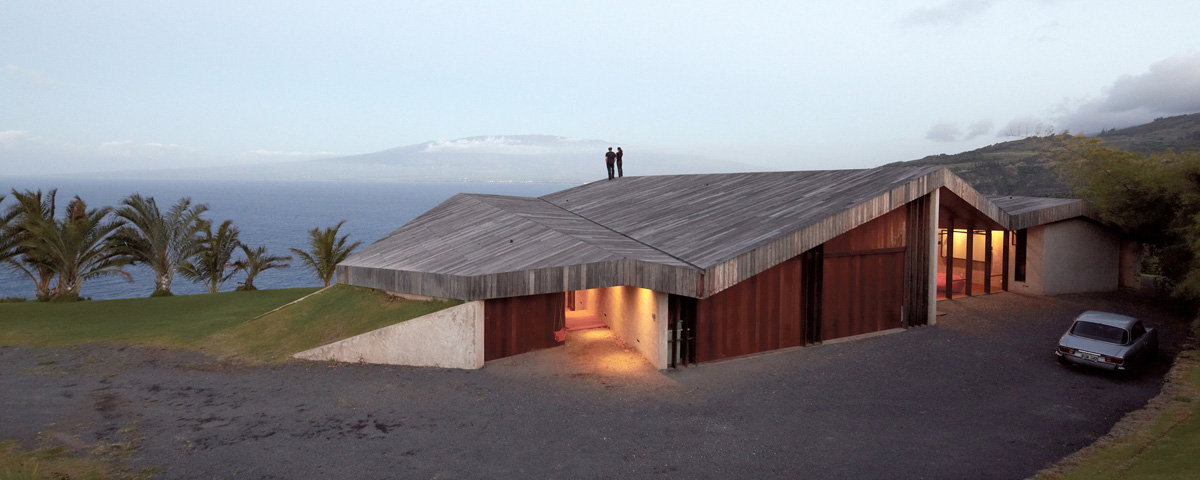 Home on a cliff in Hawaii. A common roof encloses several 