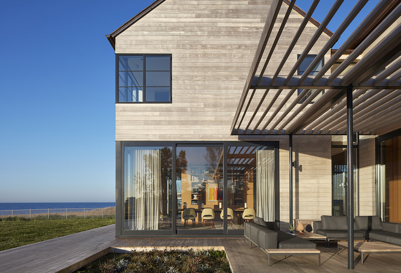 St. Joseph Residence: group of vernacular volumes rest on a green lawn overlooking the lake