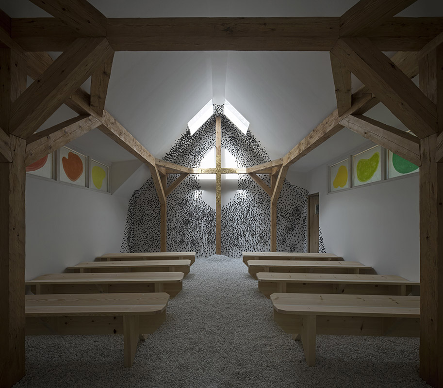 Wooden cross inside the Chapel at the Venice Biennale covered in gold leaves