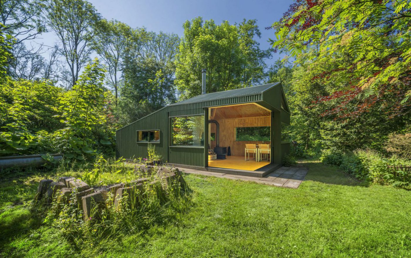 Green wooden hut in the trees