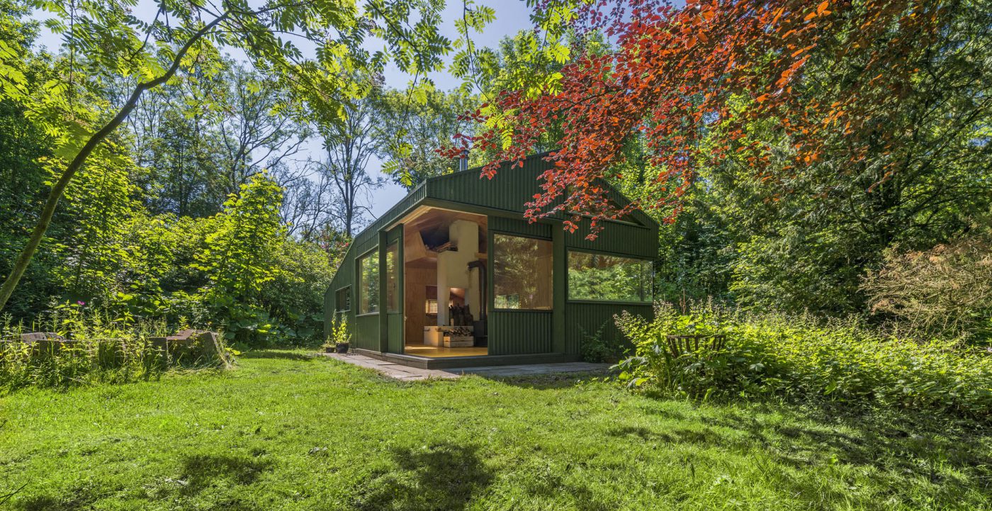 Green wooden hut in the trees
