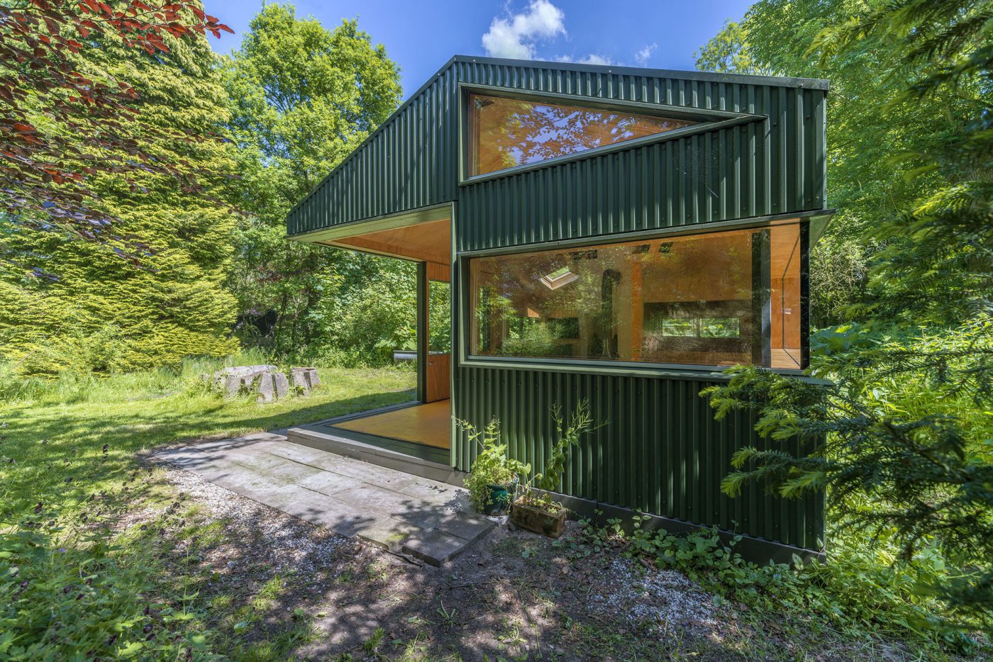 Green wooden hut in the trees