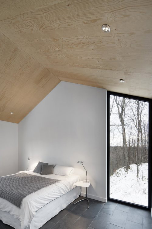 Bedroom with wooden ceiling and white walls