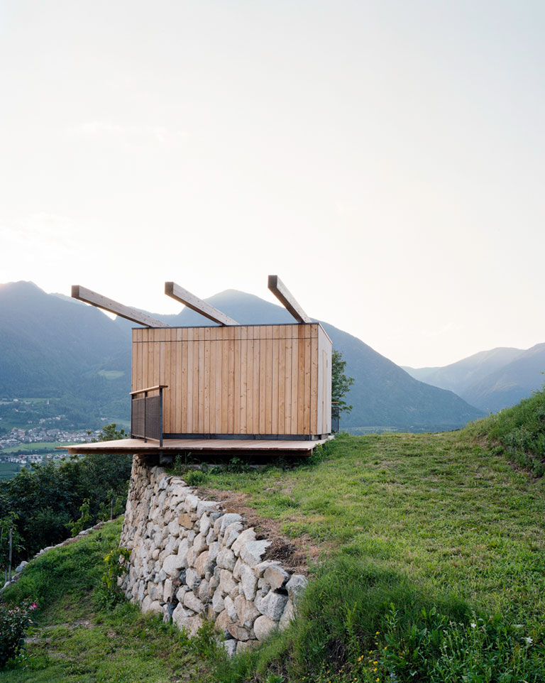 Mountain landscape with wooden architecture at its centre