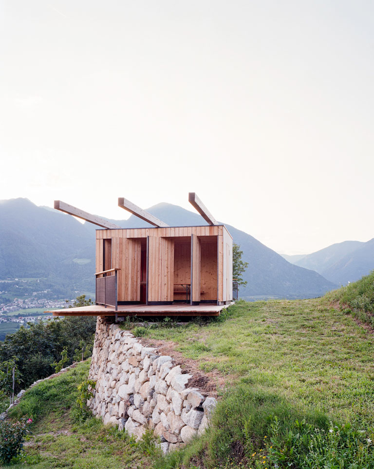 Mountain landscape with wooden architecture at its centre