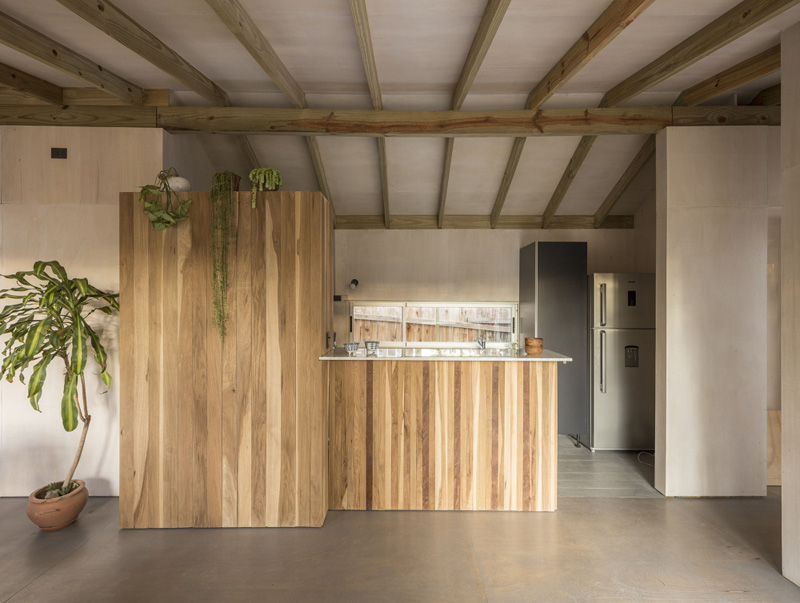 House raised by reinforced concrete beams