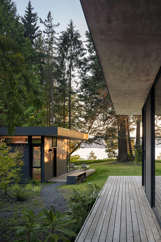 Wooden cabins among the trees on the river