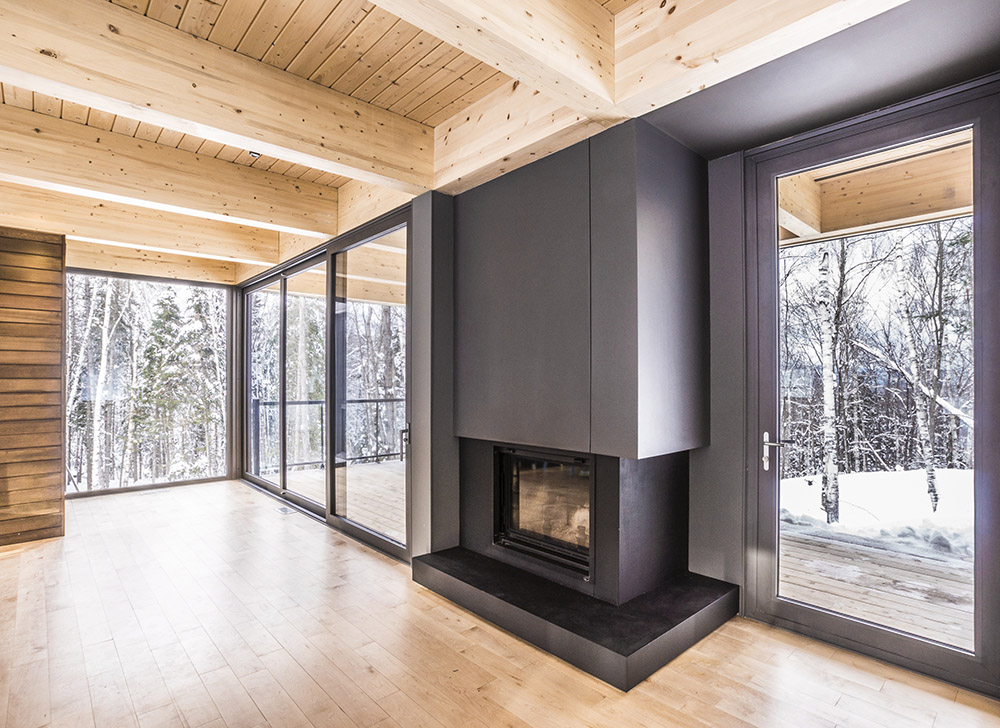 Interior home with windows and views of the forest