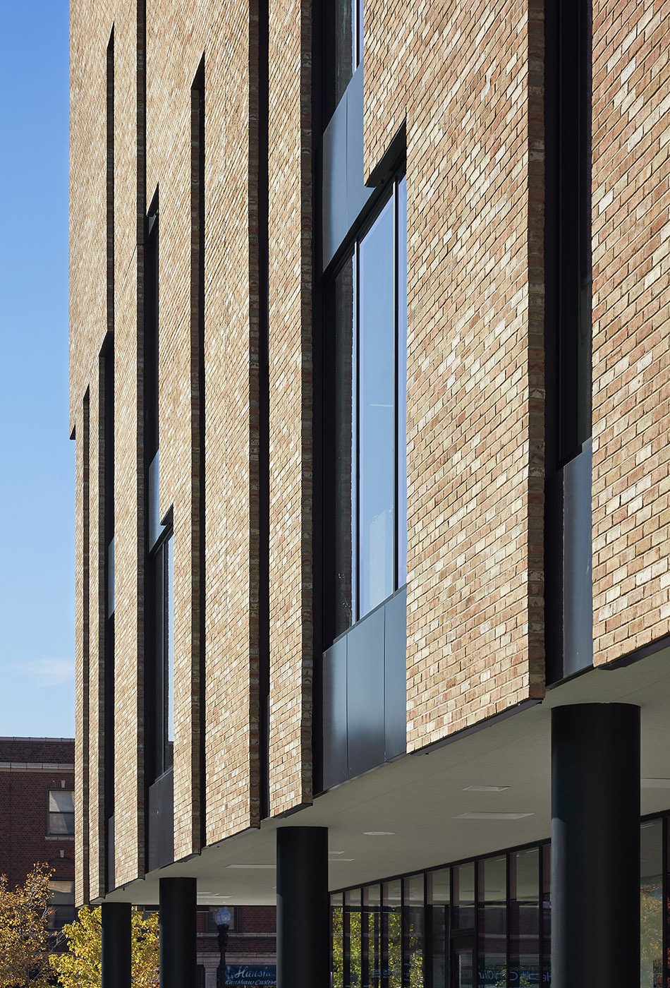 New entrance for a school. Brick and glass provide a new stylistic identity for existing buildings
