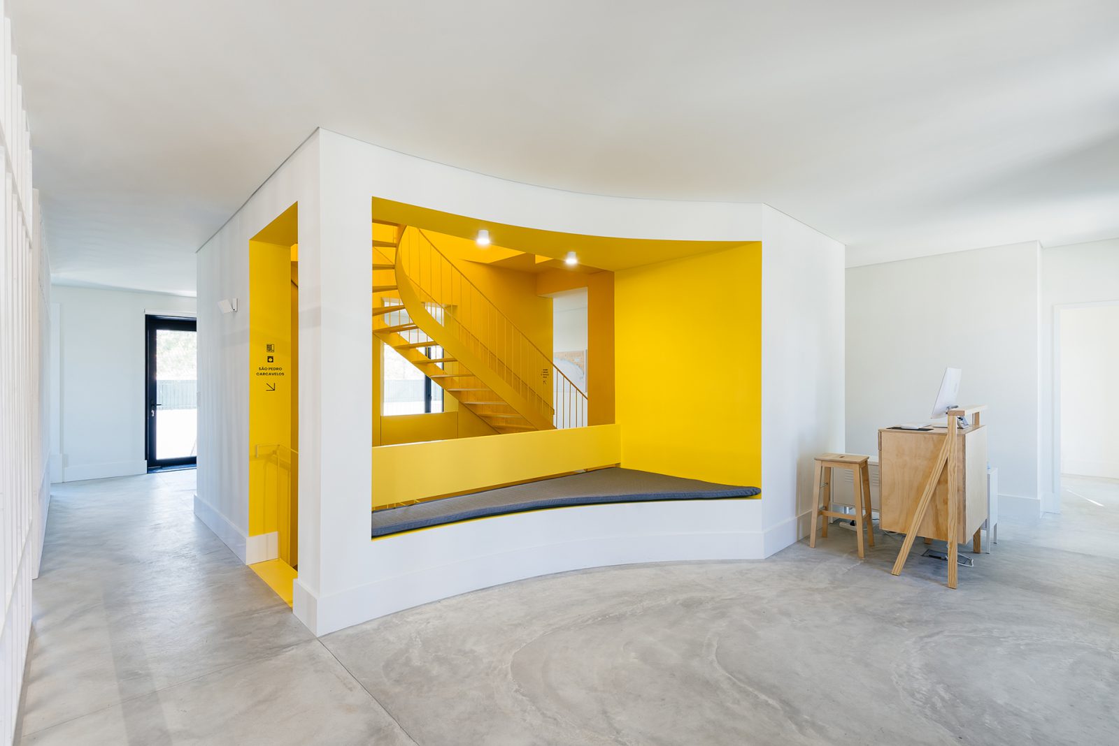 The stairwell is completely yellow with the metal staircase