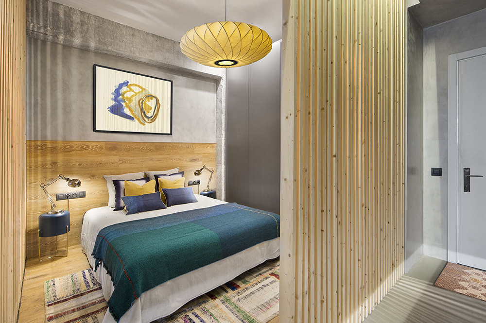 A wooden cube wraps around the bedroom