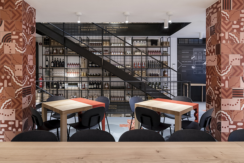 Restaurant with colored columns and internal wooden staircase