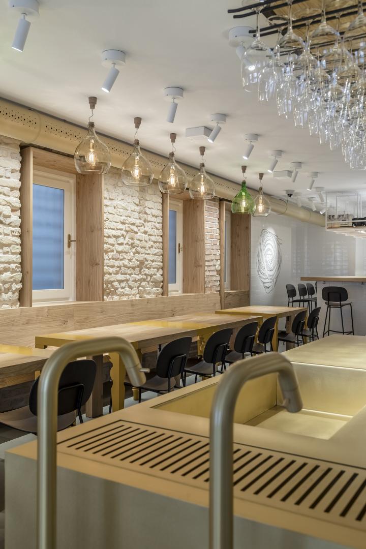 Restaurant with colored columns and internal wooden staircase