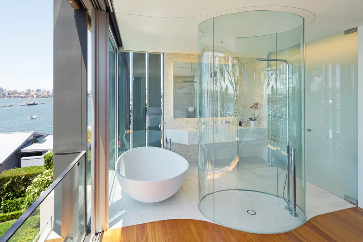 Bright bathroom with circular glass shower cubicle
