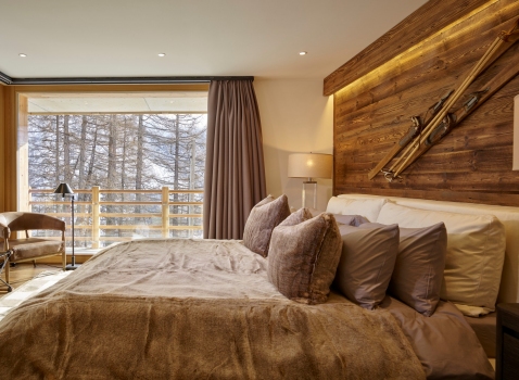 Bedroom of a resort in wood and stone