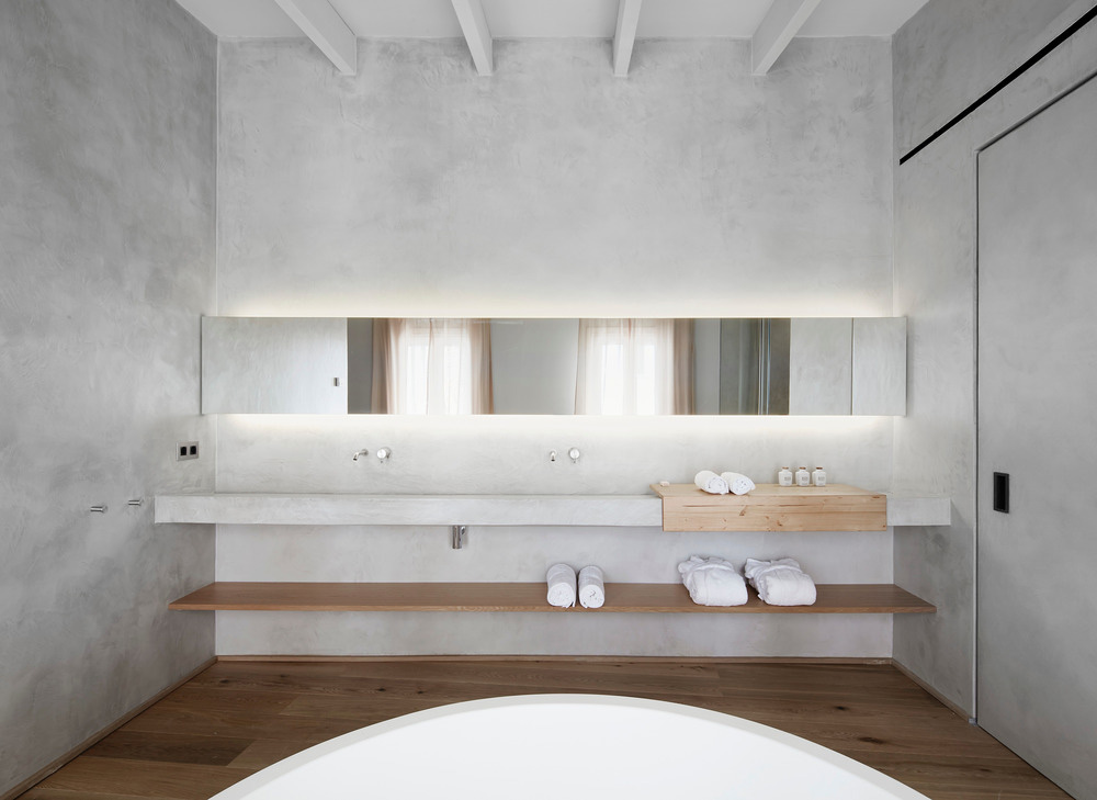 minimal hotel bathroom in grey and wood