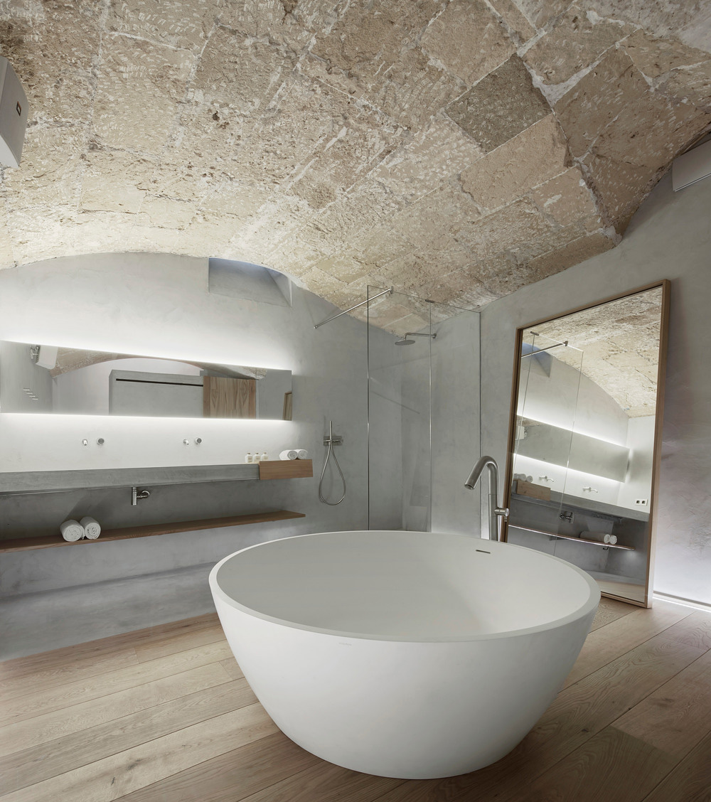 Hotel bathroom with stone walls and circular bathtub