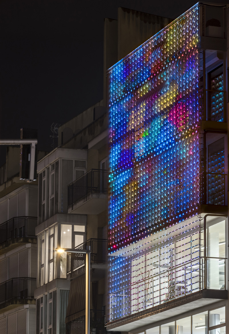 Night facade perforated metal colored lights
