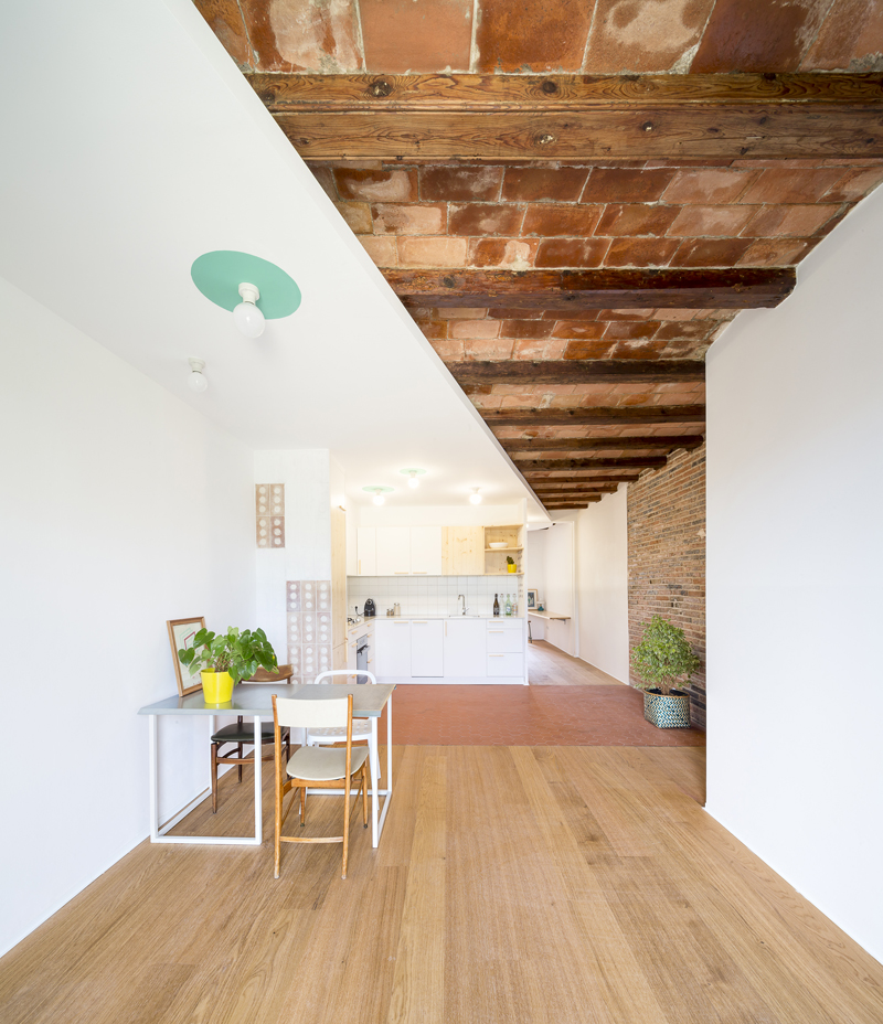 open space brick ceiling with continuous counterceiling wooden floor