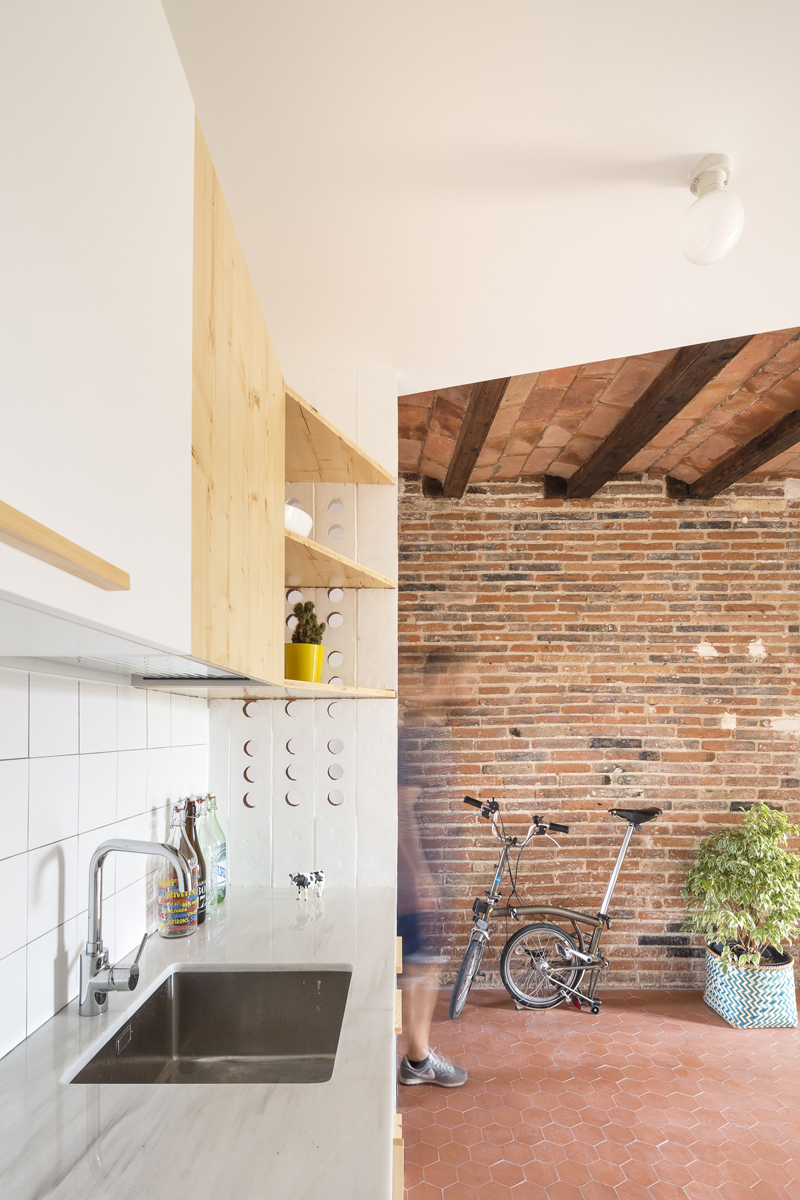open space brick ceiling with continuous counterceiling wooden floor