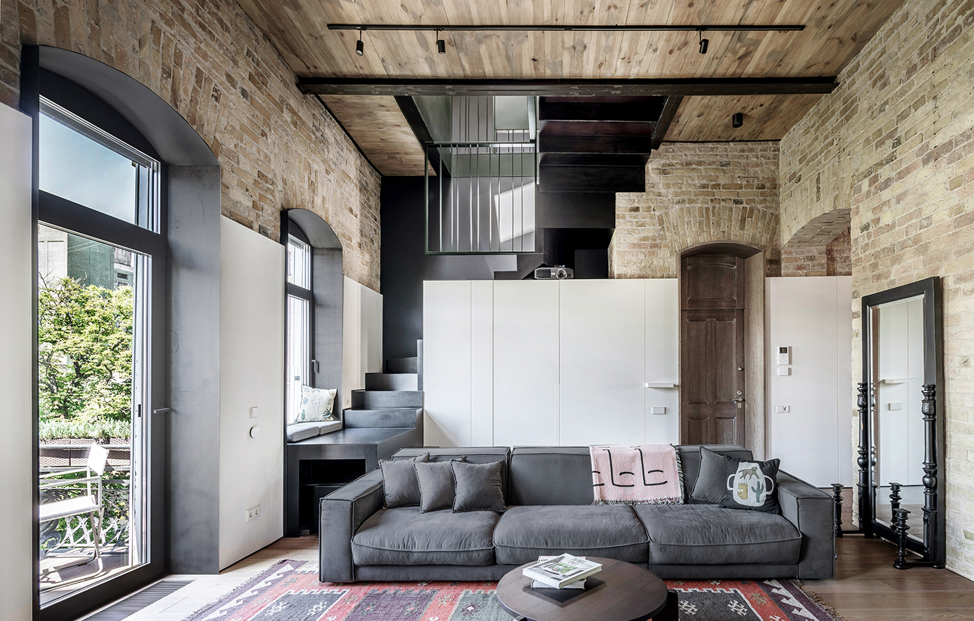 Old walls and exposed wooden beams. Apartment for a young professional