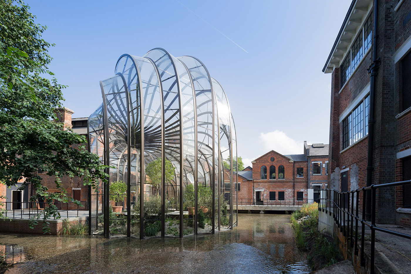 Glass greenhouse between historic buildings