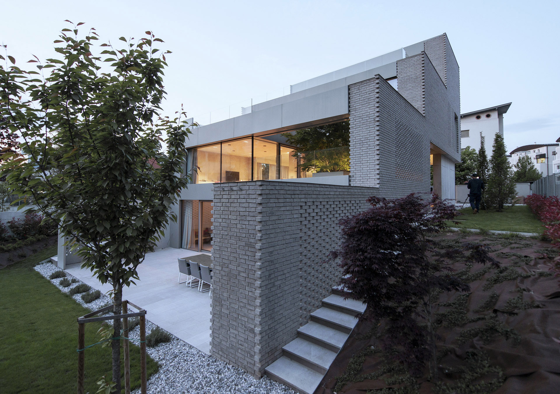 A fabric of perforated bricks surrounds the Step Level House