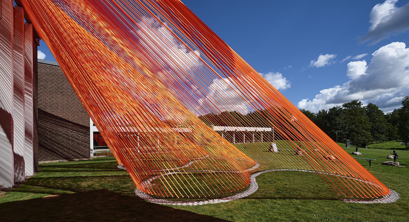 A pavilion of orange threads. United but separate to reflect on the historical moment we are living in