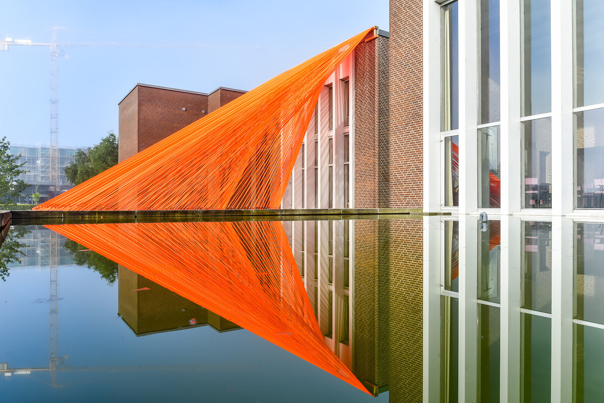 A pavilion of orange threads. United but separate to reflect on the historical moment we are living in