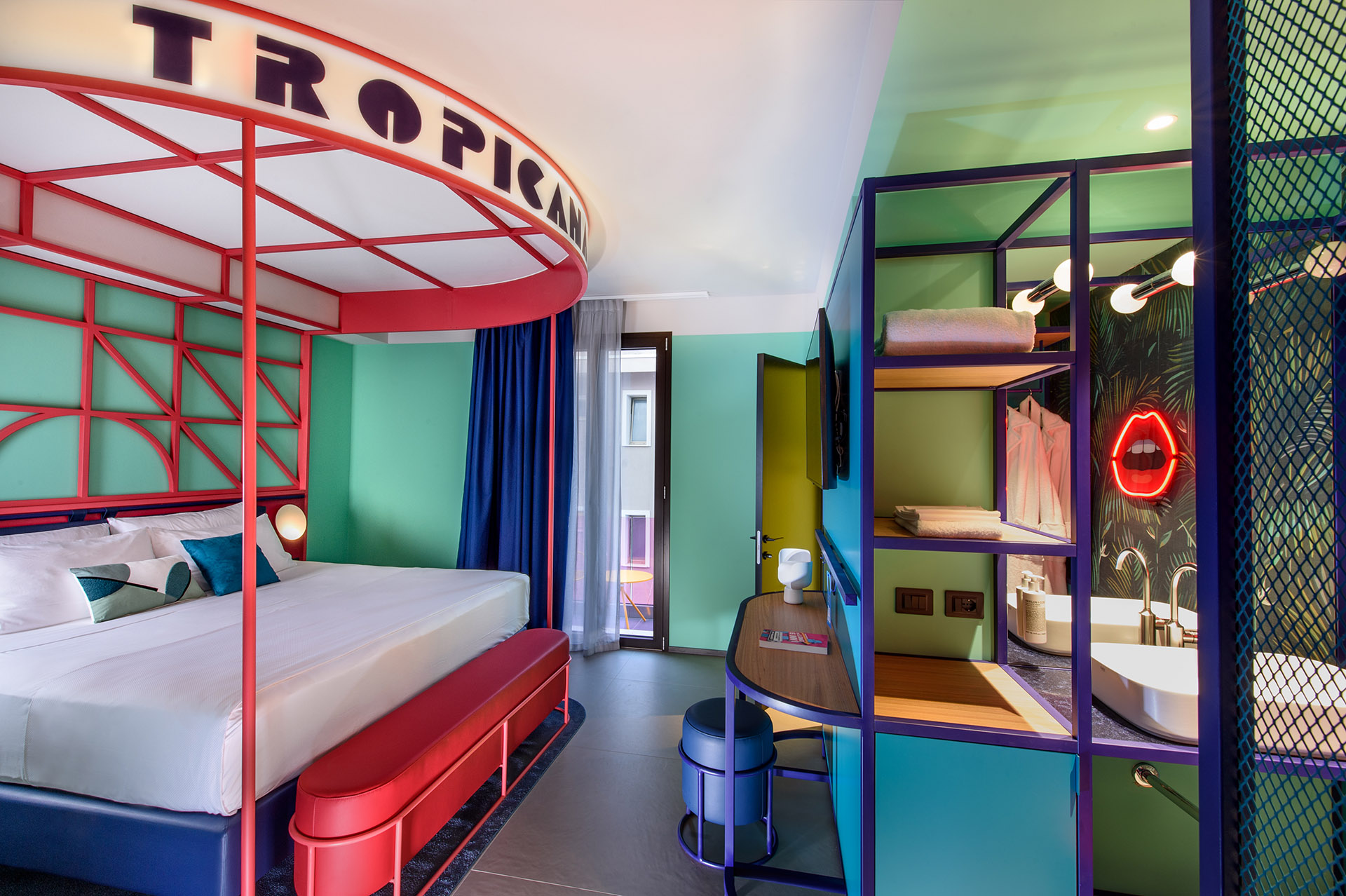 Arredi iconici, colori intensi e allestimento outdoor tropicale nella suite “Tropicana Club” a Rimini