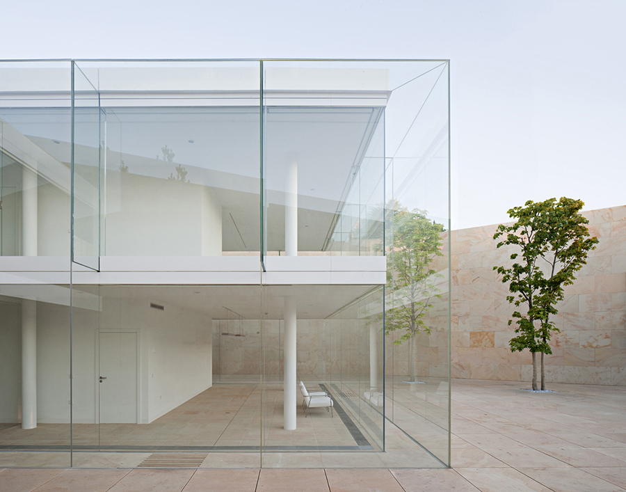 office building glass facade continuous stone flooring