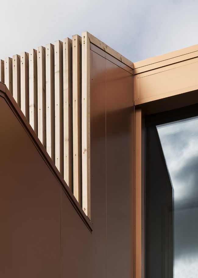 Juego de volúmenes tradicionales de un granero. Formas y paleta de materiales locales