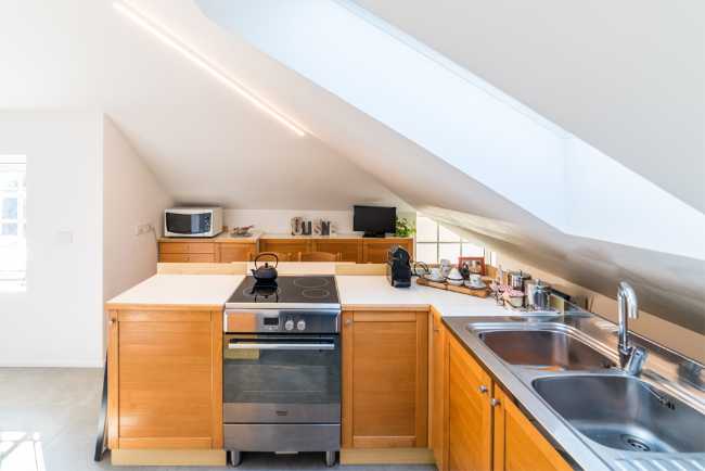 Attic transformed into living space. White and natural light to expand the rooms