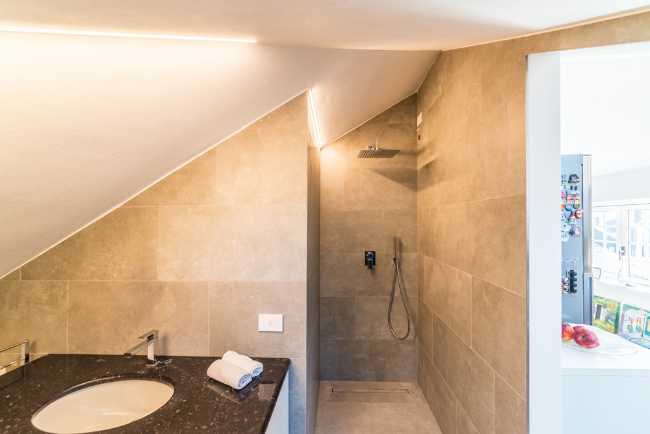 Attic transformed into living space. White and natural light to expand the rooms