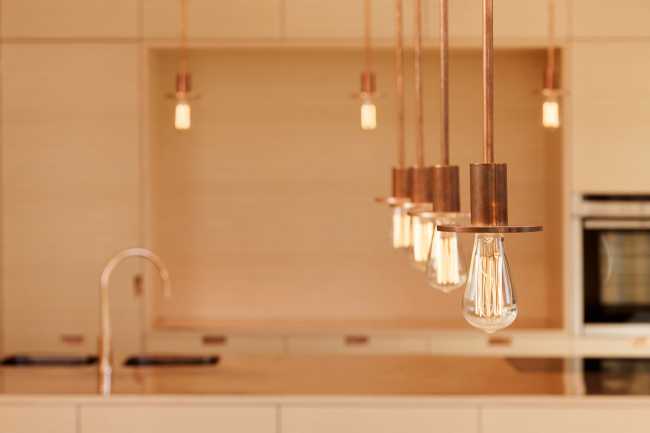 Minimal design for a wooden house. Harmony between the larch wood exterior and the landscape