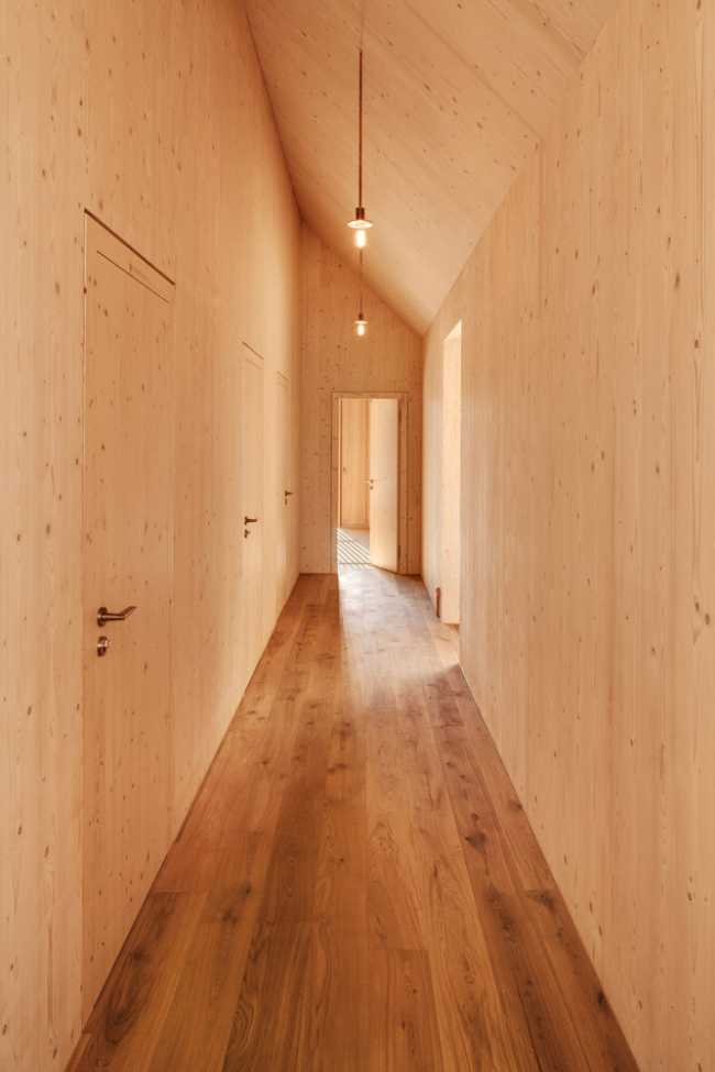 Minimal design for a wooden house. Harmony between the larch wood exterior and the landscape