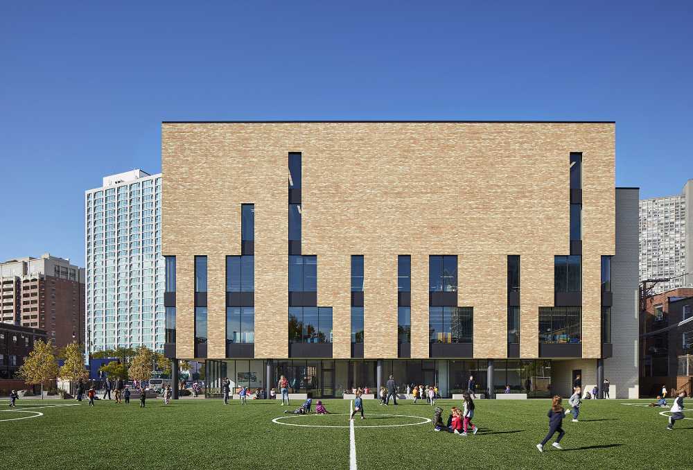 New entrance for a school. Brick and glass provide a new stylistic identity for existing buildings