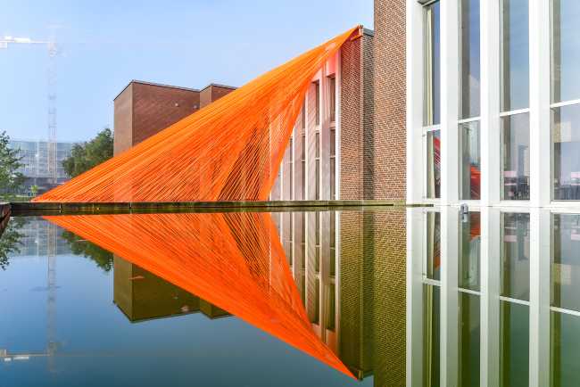 A pavilion of orange threads. United but separate to reflect on the historical moment we are living in