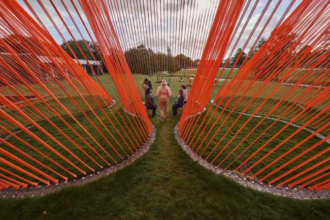 A pavilion of orange threads. United but separate to reflect on the historical moment we are living in