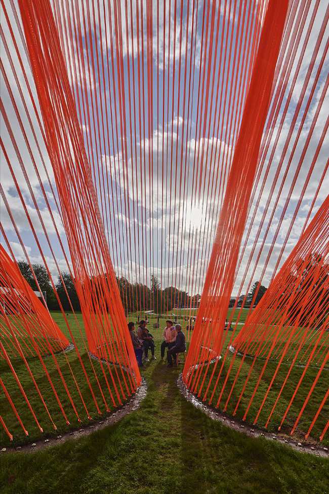 A pavilion of orange threads. United but separate to reflect on the historical moment we are living in