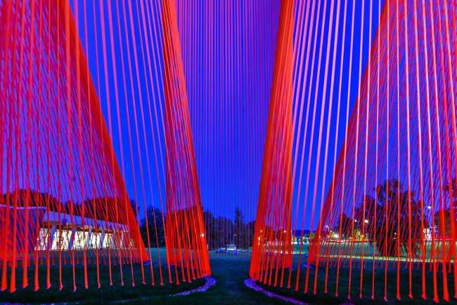 A pavilion of orange threads. United but separate to reflect on the historical moment we are living in