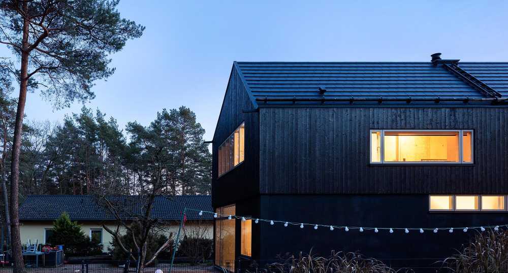 Wooden dwelling with dark tones. Glossy surfaces ranging from deep black to silver and bluish tones