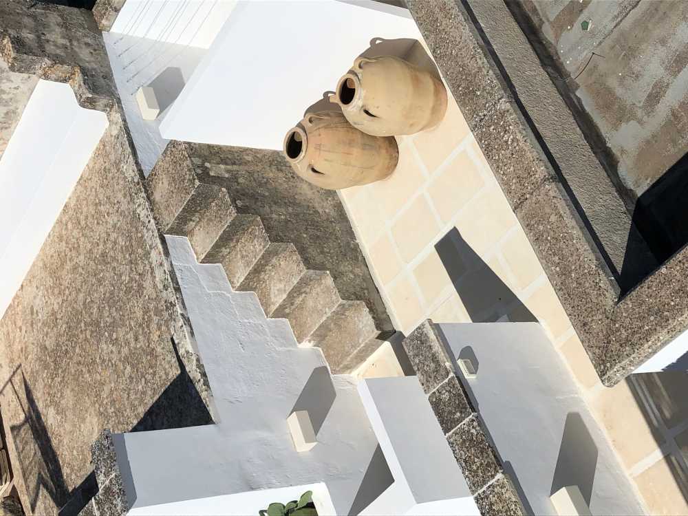 Local stone terraces and blue Mediterranean-style windows. Salentine beauty brought back to life