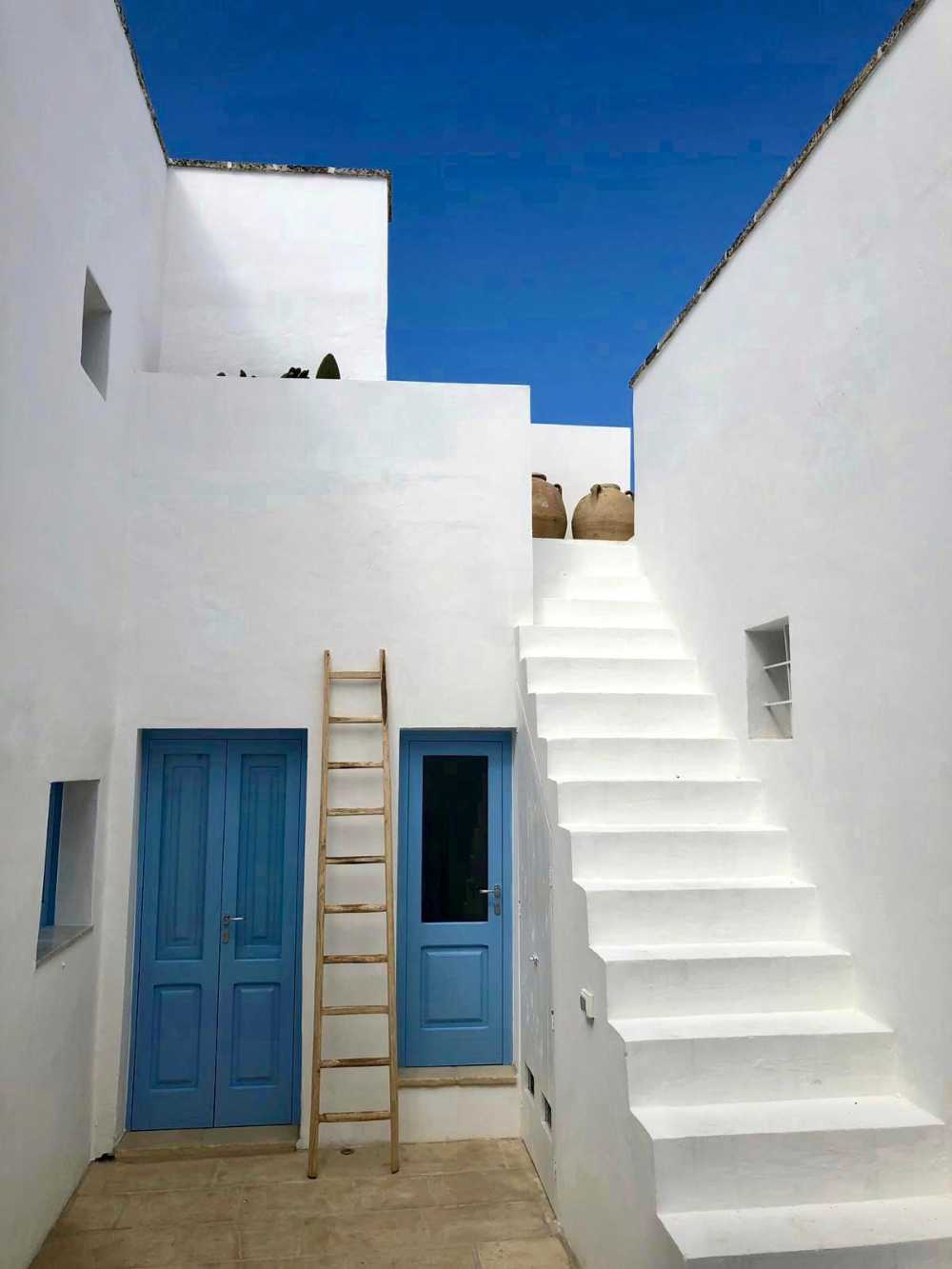 Local stone terraces and blue Mediterranean-style windows. Salentine beauty brought back to life
