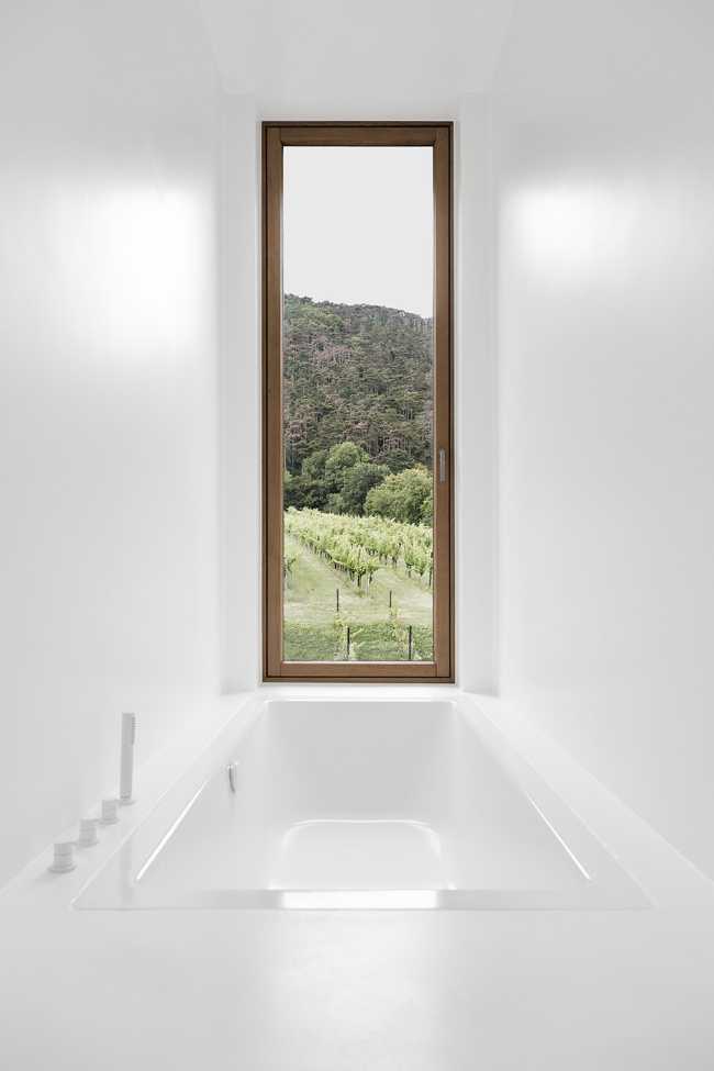 House on wine terraces. Wooden slats cover the structure like a velvety black veil