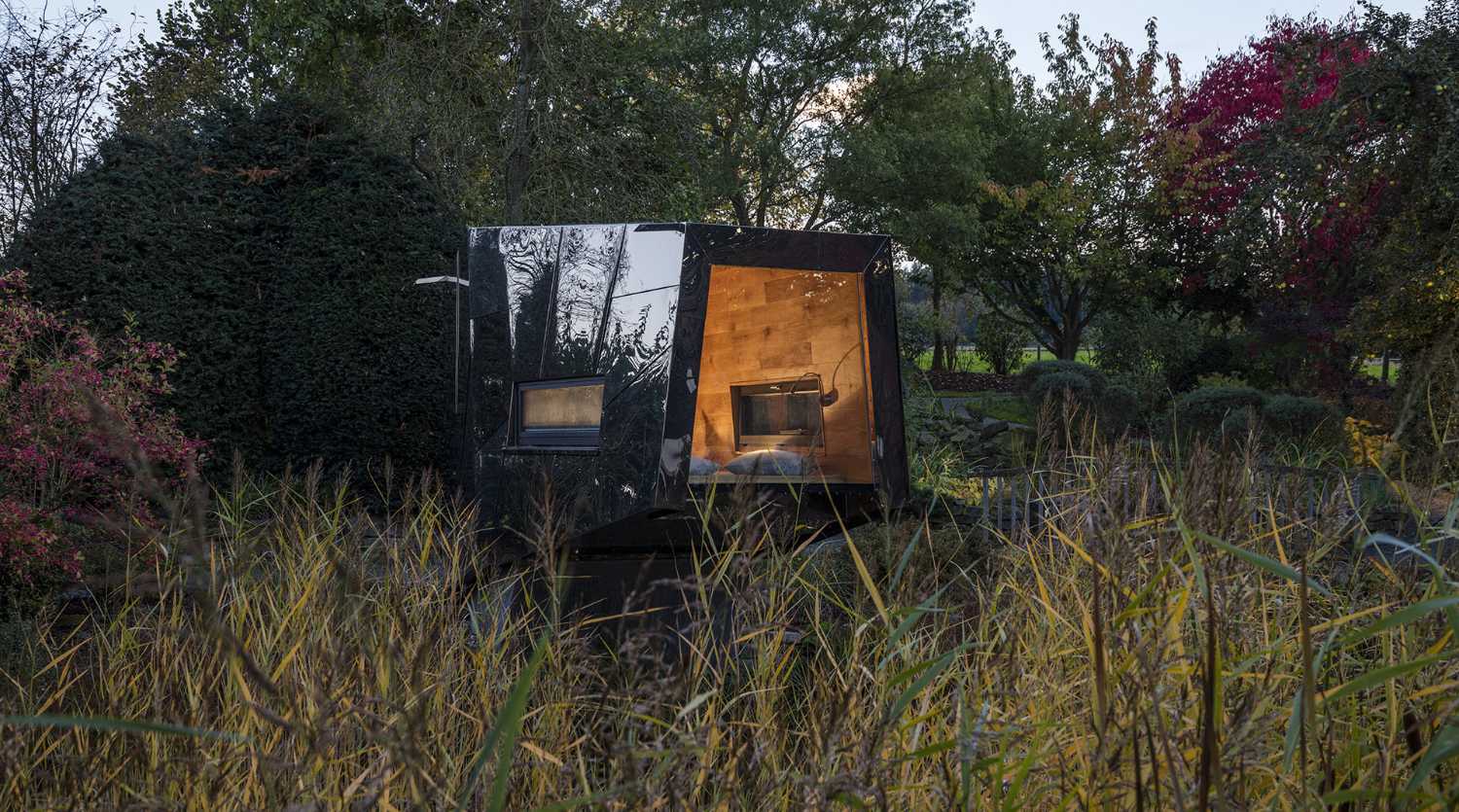 Floating Sculpted Space. The bronze colored facade elegantly reflects the environment