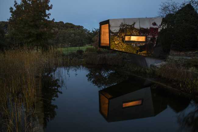 Floating Sculpted Space. The bronze colored facade elegantly reflects the environment