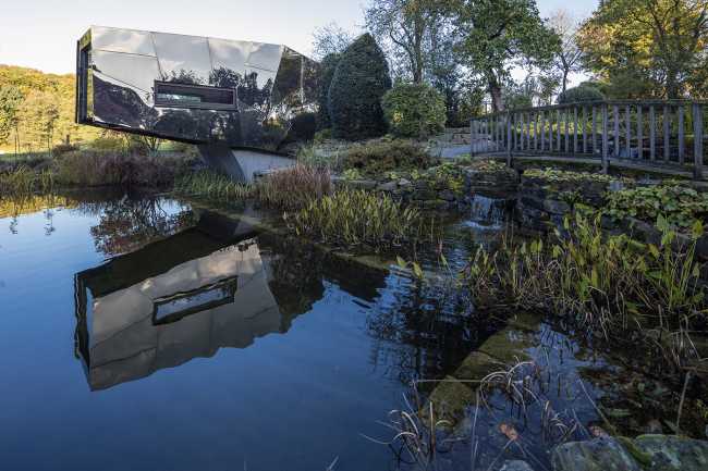 Floating Sculpted Space. The bronze colored facade elegantly reflects the environment