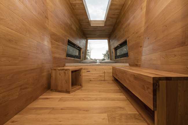 Floating Sculpted Space. The bronze colored facade elegantly reflects the environment